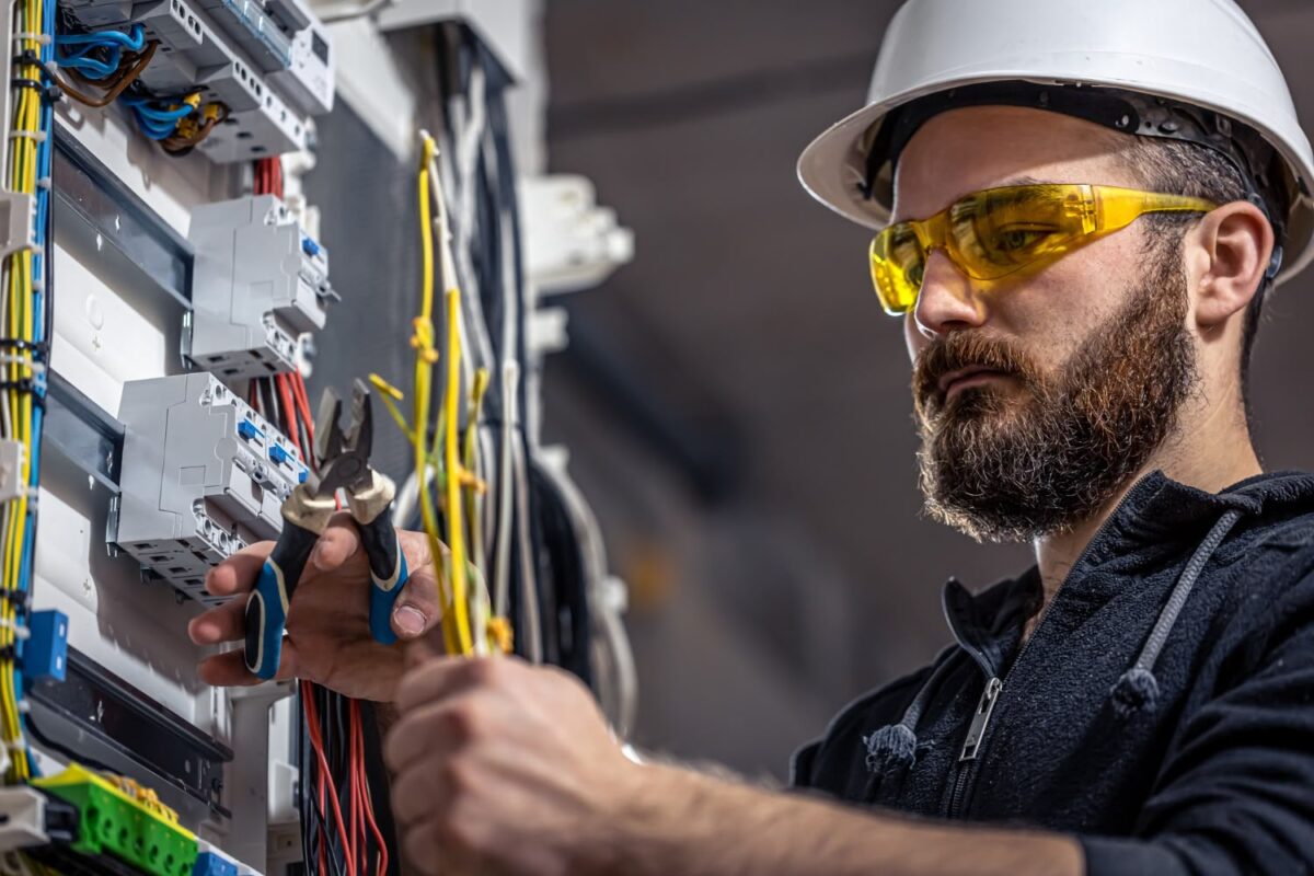Electrician working in switchboard